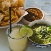 tortilla chips, dips and a drink at local Mexican restaurant