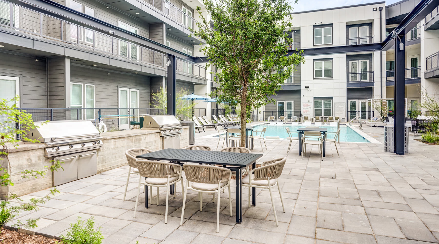 Apartments in South Austin, TX grills and eating area next to pool